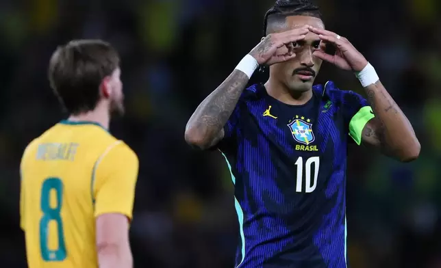 Brazil's Raphinha, right, celebrates scoring from a penalty as Australia's Connor Metcalfe walks past during their international friendly soccer match in Brisbane, Australia, on Tuesday, Sept. 29, 2026. (AP Photo/Tertius Pickard)
