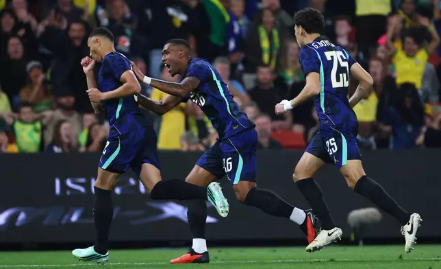 Brazil's Vanderson, left, celebrates with teammates Gabriel Bontempo, right, and Rayan after Vanderson scored a goal against Australia during their international friendly soccer match in Brisbane, Australia, on Tuesday, Sept. 29, 2026. (AP Photo/Tertius Pickard)