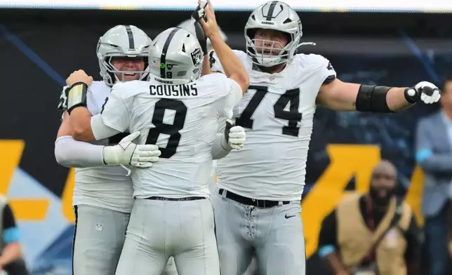 Las Vegas Raiders quarterback Kirk Cousins (8) celebrates with teammates after throwing a touchdown pass to wide receiver Cody White during the second half of an NFL football game against the Los Angeles Chargers in Inglewood, Calif., Sunday, Sept. 20, 2026. (AP Photo/Jayne Kamin-Oncea)