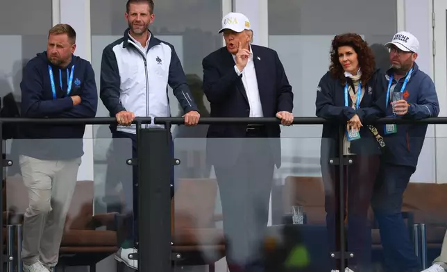 U.S. President Donald Trump and son Eric Trump watch the play during the Irish Open at the Trump International Golf Links course in Doonbeg, Ireland, Saturday, Sept. 12, 2026.(AP Photo/Peter Morrison)