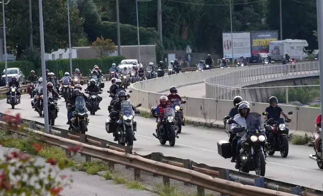 Guzzi bikers run during the Grand Parade along the route from Lecco to Mandello del Lario on Lake Como, part of the Moto Guzzi World Days 2026, as the maker celebrates its 105th anniversary, in Lecco, Italy, Saturday, Sept. 5, 2026. (AP Photo/Luca Bruno)