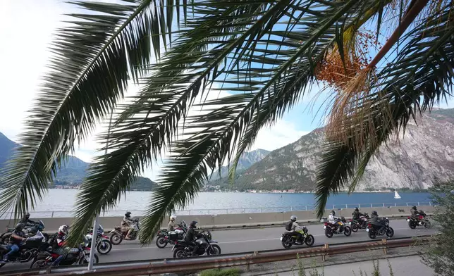Guzzi bikers run during the Grand Parade along the route from Lecco to Mandello del Lario on Lake Como, part of the Moto Guzzi World Days 2026, as the maker celebrates its 105th anniversary, in Lecco, Italy, Saturday, Sept. 5, 2026. (AP Photo/Luca Bruno)