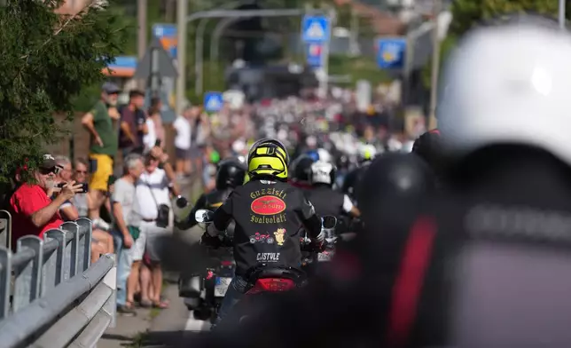 Guzzi bikers run during the Grand Parade in Mandello del Lario on Lake Como, part of the Moto Guzzi World Days 2026, as the maker celebrates its 105th anniversary, in Lecco, Italy, Saturday, Sept. 5, 2026. (AP Photo/Luca Bruno)