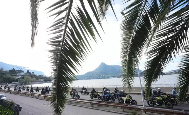 Guzzi bikers run during the Grand Parade along the route from Lecco to Mandello del Lario on Lake Como, part of the Moto Guzzi World Days 2026, as the maker celebrates its 105th anniversary, in Lecco, Italy, Saturday, Sept. 5, 2026. (AP Photo/Luca Bruno)