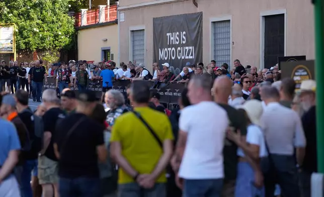 Riders and visitors wait in line during the Moto Guzzi opening inaugurating its completely redeveloped historic factory and new museum as the motorcycle maker celebrates its 105th anniversary, in Mandello del Lario, Thursday, Sept. 3, 2026. (AP Photo/Luca Bruno)