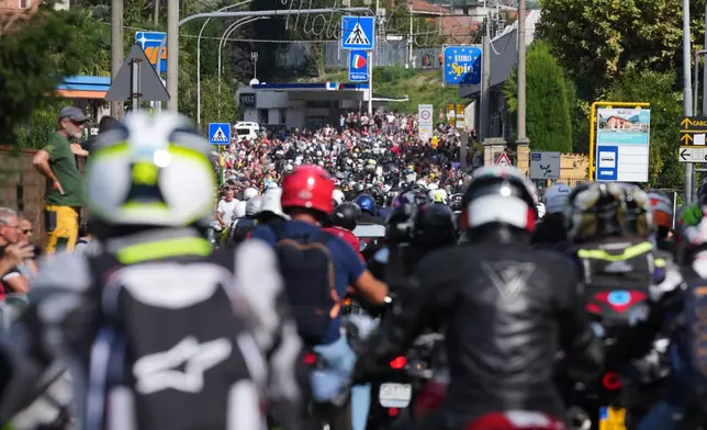 Guzzi bikers run during the Grand Parade in Mandello del Lario on Lake Como, part of the Moto Guzzi World Days 2026, as the maker celebrates its 105th anniversary, in Lecco, Italy, Saturday, Sept. 5, 2026. (AP Photo/Luca Bruno)