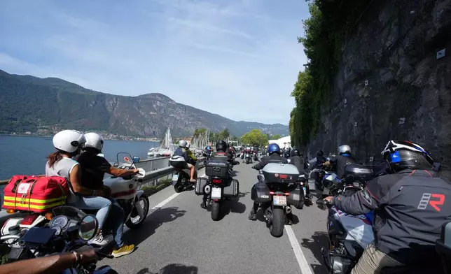 Guzzi bikers run during the Grand Parade along the route from Lecco to Mandello del Lario on Lake Como, part of the Moto Guzzi World Days 2026, as the maker celebrates its 105th anniversary, in Lecco, Italy, Saturday, Sept. 5, 2026. (AP Photo/Luca Bruno)