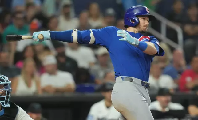 Chicago Cubs' Ian Happ hits a single to bring in two runs during the third inning of a baseball game against the Miami Marlins Saturday, Sept. 5, 2026, in Miami. (AP Photo/Marta Lavandier)