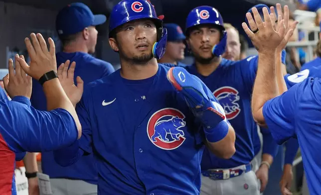 Chicago Cubs' Seiya Suzuki and Miguel Amaya celebrate after scoring on a single by Ian Happ during the third inning of a baseball game against the Miami Marlins Saturday, Sept. 5, 2026, in Miami. (AP Photo/Marta Lavandier)