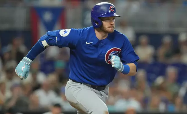 Chicago Cubs' Ian Happ runs to first base after hitting a single to bring in two runs during the third inning of a baseball game against the Miami Marlins Saturday, Sept. 5, 2026, in Miami. (AP Photo/Marta Lavandier)