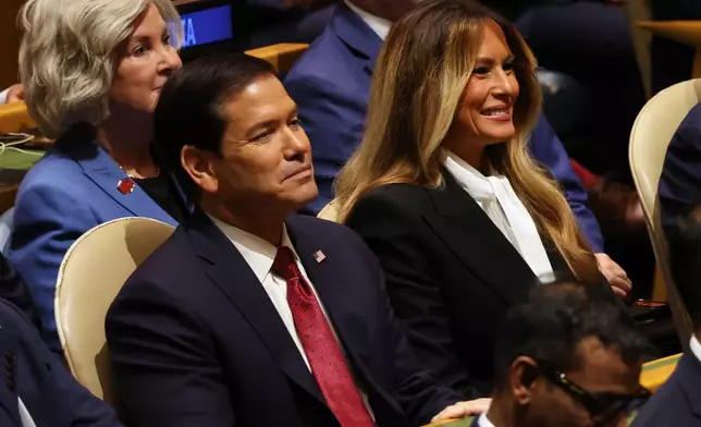 United States Secretary of State Marco Rubio, left, and United States first lady Melania Trump listen as United States President Donald Trump speaks during the 81st session of the United Nations General Assembly at United Nations headquarters, Tuesday, Sept. 22, 2026. (AP Photo/Heather Khalifa)