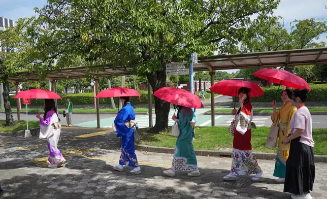 Women in traditional Japanese kimonos walk near the athletes village at the Asian Games in Nagoya, Japan, Friday, Sept. 18, 2026. (AP Photo/Dita Alangkara)