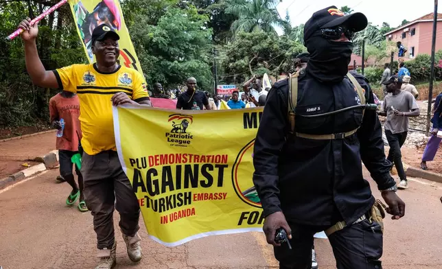 Members of the Patriotic League of Uganda demonstrate outside the Turkish Embassy demanding the extradition of a dissident, Fred Lumbuye, whose online activities are seen by local authorities as anti-government propaganda in Kampala, Uganda, Friday, Sept. 18, 2026. (AP Photo/Hajarah Nalwadda)