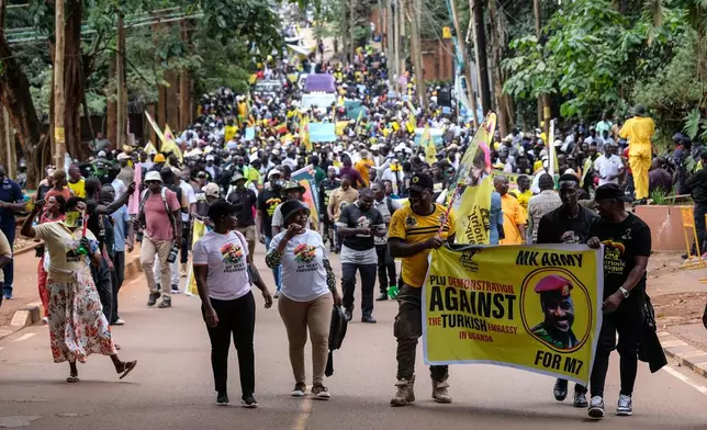 Members of the Patriotic League of Uganda demonstrate outside the Turkish Embassy demanding the extradition of a dissident, Fred Lumbuye, whose online activities are seen by local authorities as anti-government propaganda in Kampala, Uganda, Friday, Sept. 18, 2026. (AP Photo/Hajarah Nalwadda)