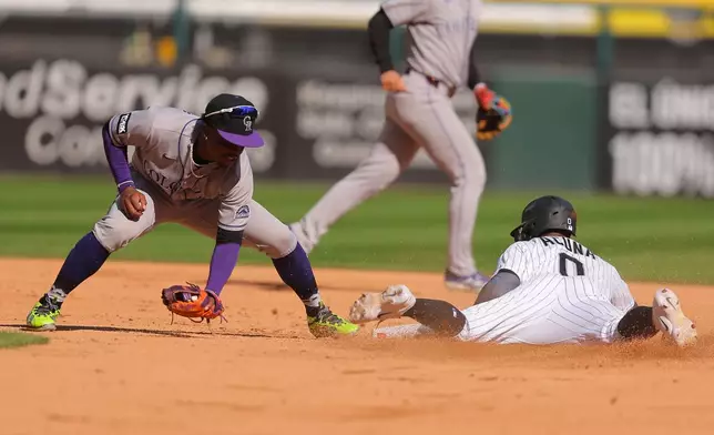 Chicago White Sox's Luisangel Acuña, right, steals second base against Colorado Rockies' Adael Amador, left, during the third inning of a baseball game, Sunday, Sept. 27, 2026, in Chicago. (AP Photo/Melissa Tamez)