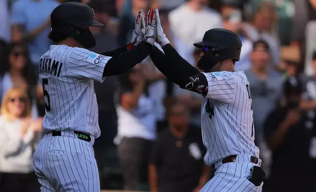Chicago White Sox's Brenton Doyle, right, celebrates after his two-run home run with Munetaka Murakami, left, during the third inning of a baseball game against the Colorado Rockies, Sunday, Sept. 27, 2026, in Chicago. (AP Photo/Melissa Tamez)