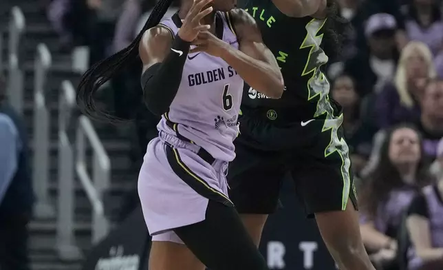 Seattle Storm guard Flau'jae Johnson, right, reaches for the ball over Golden State Valkyries guard-forward Kaila Charles (6) during the first half of a WNBA basketball game in San Francisco, Saturday, Sept. 19, 2026. (AP Photo/Jeff Chiu)
