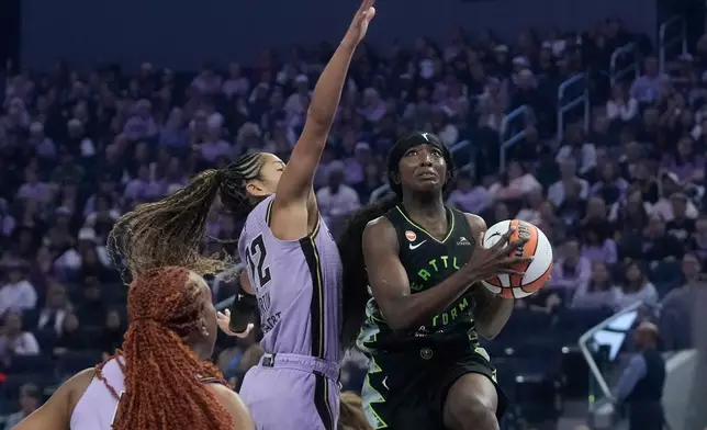 Seattle Storm guard Flau'jae Johnson, right, shoots against Golden State Valkyries guard Veronica Burton, middle, during the first half of a WNBA basketball game in San Francisco, Saturday, Sept. 19, 2026. (AP Photo/Jeff Chiu)
