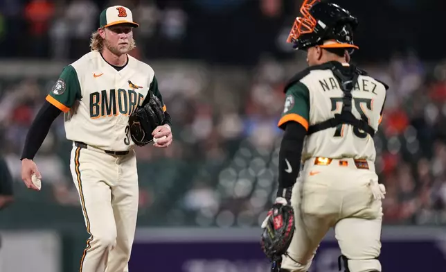 Baltimore Orioles starting pitcher Shane Baz, left, talks with catcher Carlos Narváez (75) during a mound visit in the third inning of a baseball game against the Boston Red Sox, Friday, Sept. 4, 2026, in Baltimore. (AP Photo/Stephanie Scarbrough)