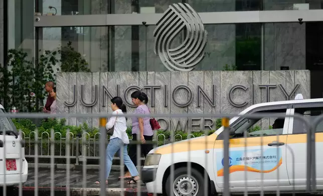 Pedestrians walk past entrance of Junction City office tower Tuesday, Sept. 15, 2026, in Yangon, Myanmar. (AP Photo)