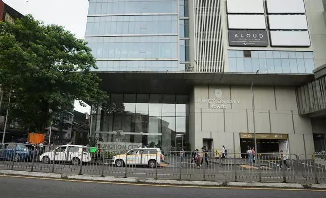 Pedestrians walk past entrance of Junction City office tower Tuesday, Sept. 15, 2026, in Yangon, Myanmar. (AP Photo)