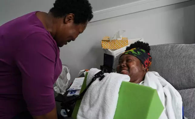 Jacqueline Davis, left, and her daughter, Ebony Payne, a disability advocate who is quadriplegic, laugh at their home in Chicago, Ill., on Thursday, Sept. 10, 2026. (AP Photo/Luis Andres Henao)