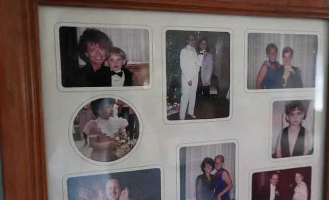 A framed collage of family photos of Deb Robertson and her wife, Kate Koubek, hangs from a wall at their home in Lombard, Ill., on Tuesday, Sept. 8, 2026. (AP Photo/Luis Andres Henao)