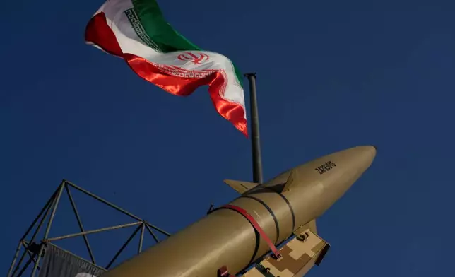 An Iranian missile is displayed under the country's national flag in a military exhibition commemorating the anniversary of the start of the 1980-88 Iraq-Iran war at Baharestan Square, in Tehran, Monday, Sept. 28, 2026. (AP Photo/Vahid Salemi)