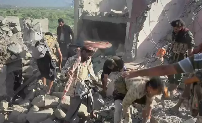 This image taken from video released by Al-Masirah TV, a channel run by Yemen's Houthi rebels, on Monday, Sept. 28, 2026, shows what the channel said were Houthi fighters and local residents searching through the rubble of a house following a strike by Saudi-backed forces in the town of Kadhah, in Taiz province, Yemen. (Al-Masirah TV via AP)