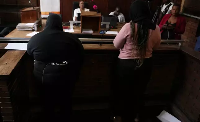 Two women appear in Boksburg Magistrate Court, east of Johannesburg, South Africa, Monday, Sept. 21, 2026, in connection with one of a series of killings of women in Johannesburg. (AP Photo/Themba Hadebe)