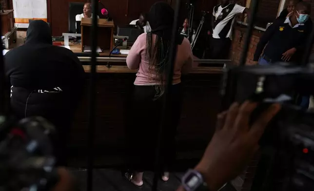 Two women appear in Boksburg Magistrate Court, east of Johannesburg, South Africa, Monday, Sept. 21, 2026, in connection with one of a series of killings of women in Johannesburg. (AP Photo/Themba Hadebe)