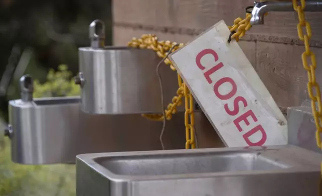 A sign is seen as officials at Grand Canyon National Park in northern Arizona have closed off access to water sources at the park after a flash flood damaged the only water pipeline that serves the canyon, Monday, Aug. 31, 2026. (AP Photo/Ty ONeil)