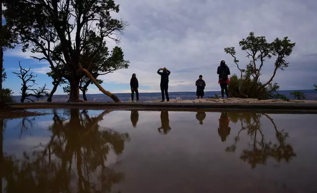 People stand at the rim of the Grand Canyon, Monday, Aug. 31, 2026, in Grand Canyon National Park, Ariz. (AP Photo/John Locher)