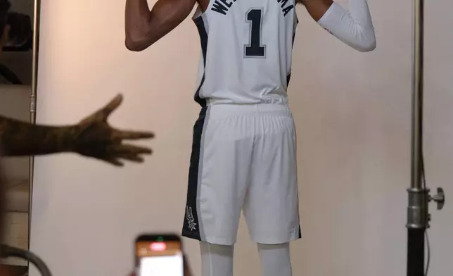 San Antonio Spurs center Victor Wembanyama poses for photos during the team's NBA basketball media day event, Monday, Sept. 28, 2026, in San Antonio. (AP Photo/Darren Abate)