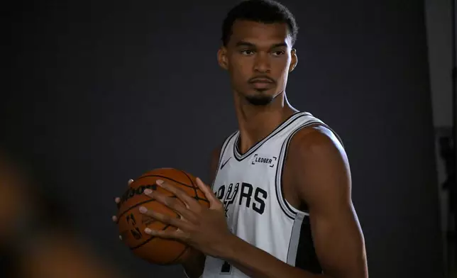 San Antonio Spurs center Victor Wembanyama poses for photos during the team's NBA basketball media day event, Monday, Sept. 28, 2026, in San Antonio. (AP Photo/Darren Abate)
