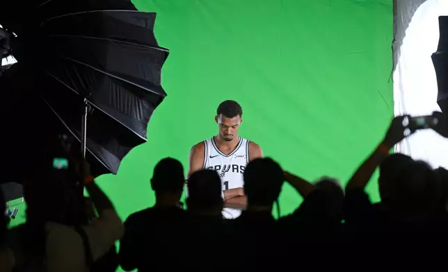 San Antonio Spurs center Victor Wembanyama poses for photos during the team's NBA basketball media day event, Monday, Sept. 28, 2026, in San Antonio. (AP Photo/Darren Abate)