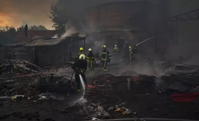 Firefighters try to extinguish a fire following a Russian missile attack in Kyiv, Ukraine, early Tuesday, Sept. 8, 2026. (AP Photo/Francisco Seco)