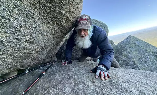 Dale Sanders, 91, climbs a section of Mt. Katahdin, Monday, Aug. 31, 2026 in Baxter State Park in Piscataquis County, Maine. (AP Photo/Robert F. Bukaty)