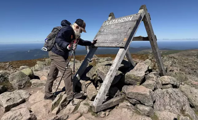 Dale Sanders, 91, pauses for a prayer upon completing his hike of the Appalachian Trail at the summit of Mt. Katahdin, Monday, Aug. 31, 2026 in Baxter State Park in Piscataquis County, Maine. (AP Photo/Robert F. Bukaty)