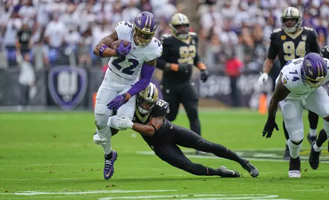Baltimore Ravens running back Derrick Henry (22) carries against New Orleans Saints safety Justin Reid (21) in the first half of an NFL football game in Baltimore, Sunday, Sept. 20, 2026. (AP Photo/Stephanie Scarbrough)