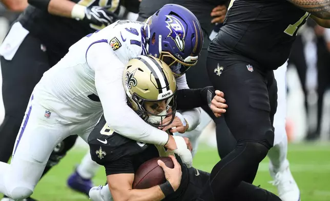 New Orleans Saints quarterback Tyler Shough (6) is sacked by Baltimore Ravens linebacker Trey Hendrickson (91) in the second half of an NFL football game in Baltimore, Sunday, Sept. 20, 2026. (AP Photo/Nick Wass)