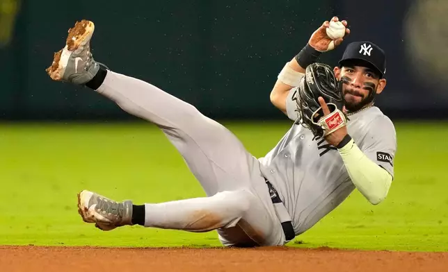New York Yankees shortstop José Caballero throws out Los Angeles Angels' Tyler Heineman at second after fielding a ball hit by Mike Trout during the fifth inning of a baseball game Tuesday, Sept. 1, 2026, in Anaheim, Calif. (AP Photo/Mark J. Terrill)