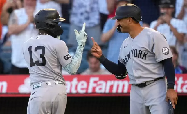 New York Yankees' Jazz Chisholm Jr., left, is congratulated by Trent Grisham after hitting a solo home run during the first inning of a baseball game against the Los Angeles Angels, Tuesday, Sept. 1, 2026, in Anaheim, Calif. (AP Photo/Mark J. Terrill)