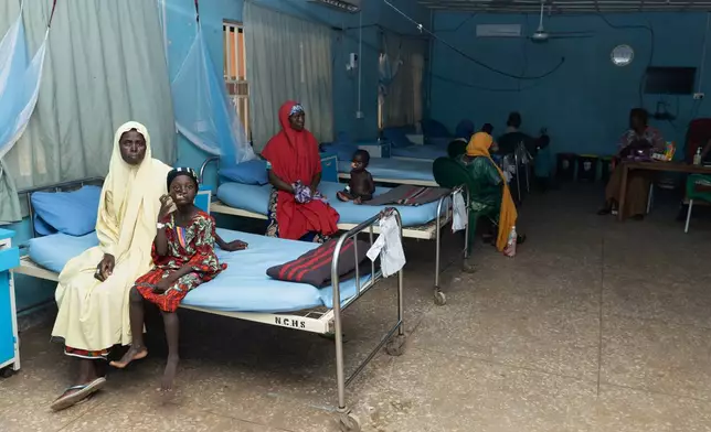 Hajira Sahabi, 2nd left, and other children who underwent facial reconstructive surgery to help them recover from noma disease, sit with relatives at the Noma Children Hospital in Sokoto, northwest Nigeria, Thursday, Sept. 3, 2026. (AP Photo/Ifeanyi Emmanuel)
