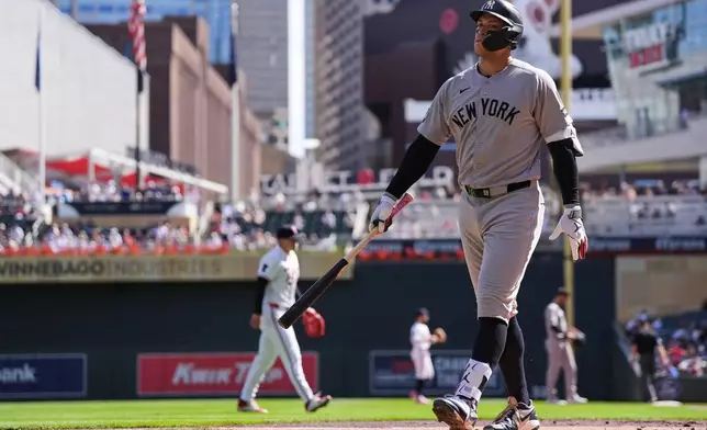 New York Yankees' Aaron Judge walks back to the dugout after striking out in the third inning of a baseball game against the Minnesota Twins, Wednesday, Sept. 16, 2026, in Minneapolis. (AP Photo/Abbie Parr)