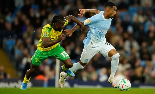 Norwich City's Benjamin Chrisene holds Manchester City's Allan Elias during the third-round English League Cup soccer match between Manchester City and Norwich City in Manchester, England, Thursday, Sept. 17, 2026. (AP Photo/Dave Thompson