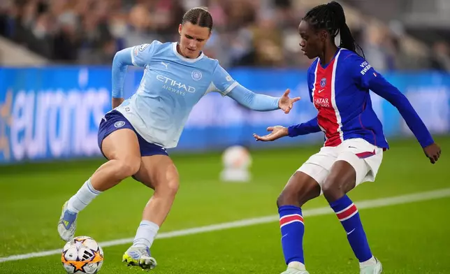 Manchester City's Kerstin Casparij, left, and Paris Saint-Germain's Jade Le Guilly battle for the ball during the Women's Champions League soccer match between Manchester City and Paris Saint-Germain in Manchester, England, Thursday, Oct. 29, 2026. (Mike Egerton/PA via AP)