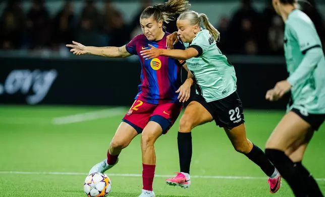 FC Barcelona's Patri Guijarro, left, and HB Koege's Emelía Óskarsdóttir in action during the women's Champions League group stage match between HB Koege and Barcelona in Koge, Denmark, Thursday Oct. 29, 2026. (Sebastian Elias Uth/Ritzau Scanpix via AP)