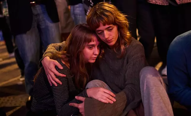 Protesters gather after the reported death of María del Carmen Abascal, the 87-year-old woman whose eviction sparked nationwide protests, in Puerta del Sol square in Madrid, Wednesday, Oct. 7, 2026. (AP Photo/Bernat Armangue)