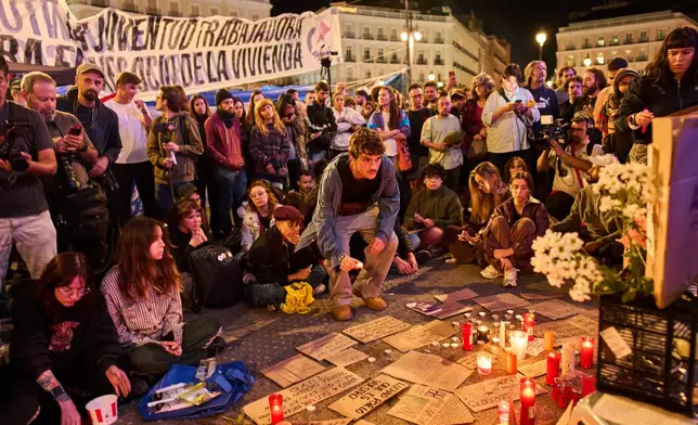 Protesters gather after the reported death of María del Carmen Abascal, the 87-year-old woman whose eviction sparked nationwide protests, in Puerta del Sol square in Madrid, early Thursday, Oct. 8, 2026. (AP Photo/Bernat Armangue)